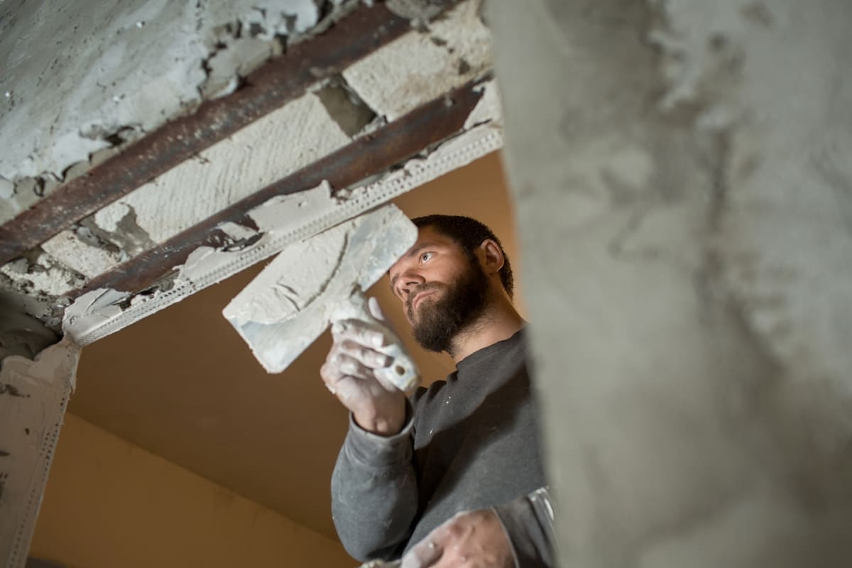 a-male-plasterer-plasters-a-concrete-wall-with-a-s-2025-01-08-07-23-42-utc (1) (1).jpg