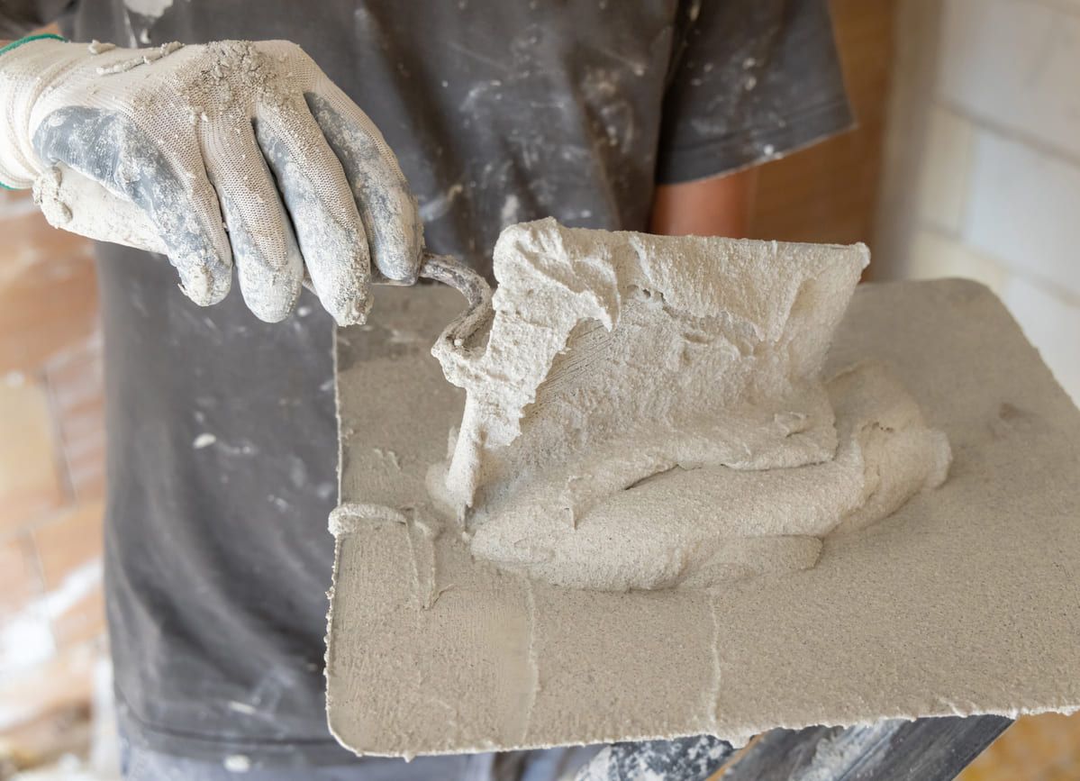 craftsman-in-dirty-gloves-puts-plaster-mortar-or-2025-03-16-15-07-25-utc (1) (1).jpg